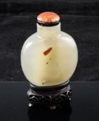 A Chinese agate snuff bottle, 19th century, of rounded flask form, with a small shadow inclusion