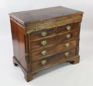 A mid 18th century oak bachelor`s chest, with blind fret frieze above a brushing slide, two short