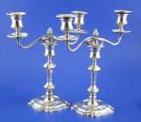 A pair of George V silver two branch two light candelabra by Goldsmiths & Silversmiths Co Ltd,