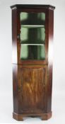 A George III mahogany corner cabinet, with single glazed door above fielded panelled door, H.6ft