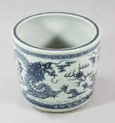 A Chinese blue and white `dragon` jardiniere, painted with two confronting dragons chasing a flaming