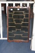 A Chinese rosewood snuff bottle cabinet, 20th century, with stepped shelves, the glazed doors with