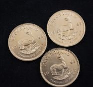 Three 1983 gold Krugerrands.