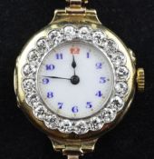 A lady`s early 20th century Swiss 18ct gold and diamond wrist watch, with Arabic dial and bezel