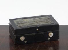 A 19th century Swiss black lacquered musical box, the lid inset with a simulated horn panel of