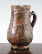 A Medieval green and ochre glazed earthenware tankard, 14th / 15th century, possibly France, with