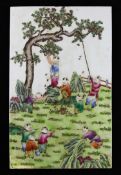 A Chinese famille rose `boys` plaque, 20th century, with children playing and picking fruit in a