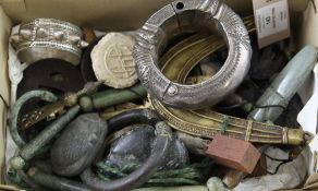 A bronze Roman bangle, Japanese iron tsubas, an Indo-Persian silver bangle, a South American green