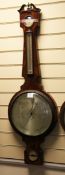 A Regency ebony strung mahogany wheel barometer, with silvered hygrometer, thermometer, dial and