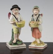 A near pair of Enoch Wood pearlware winged figures of street vendors, c.1810, each holding a