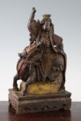 A Chinese carved wood group of an immortal riding a qilin, 18th/19th century, on a rectangular