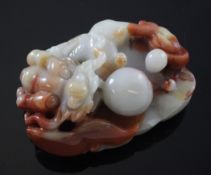 A Chinese soapstone carving of a dragon with pearl amid lingzhi fungus, the highly polished stone of