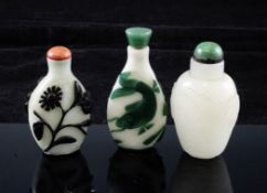 Three Chinese glass snuff bottles, early 20th century, two overlaid in green and white with a