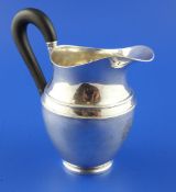 An early 19th century Austro Hungarian silver helmet shaped milk jug, with engraved armorial and