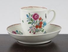 A Worcester polychrome cup and saucer, c.1770, painted with floral sprays within an urn, line, and