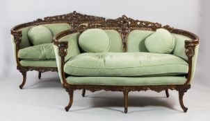 A pair of late 19th century carved and stained beech settees, the back rails carved and pierced with