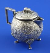 A 20th century Indian silver cream jug, of globular form, with hinged lid, elephant finial and