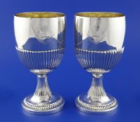 A good pair of George III demi fluted silver goblets by Stephen Adams, with engraved armorial, on