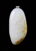 A Chinese white & russet jade snuff pebble bottle, 1760-1860, finely carved in relief to one side