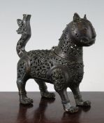 An Indo Persian cast and pierced bronze incense burner, modelled as a standing lion with hinged