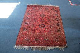 A Belouchi rug, with central geometric foliate motifs, on a russet ground, with multi row border,