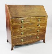A George III mahogany boxwood strung bureau, the fall front with fitted interior over two short