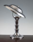 An Art Deco chrome desk lamp, with dome shade, cylindrical stepped column and circular base, 14.