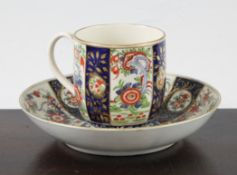 A Worcester polychrome `Queens` pattern cup and saucer, c.1770, blue fretted square seal mark to