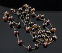 A gold and graduated banded agate bead necklace, with bead clasp, 46in.