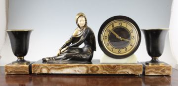 An Art Deco patinated metal and ivorine figural clock, in the manner of Manneville, 19.25in.