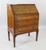An Edwardian satinwood and marquetry inlaid bureau on stand, the fall front fitted interior and