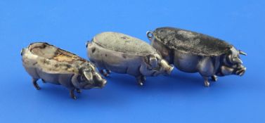 Three Edwardian silver novelty pin cushions, each modelled as a free standing pig, (two a.f.),