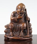 A Chinese bamboo carving of a sage with a boy in a basket, the figure seated upon a rock, 14.5cm.