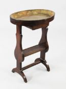 A 19th century French oval mahogany etagere, the dish top over single drawer and shelf space below