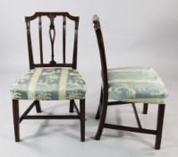 A set of six George III mahogany dining chairs, the backs carved with a central fleur de lys motif