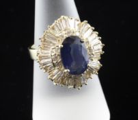 A 14ct gold oval cut sapphire, round and baguette cut diamond cluster ballerina ring, size O.