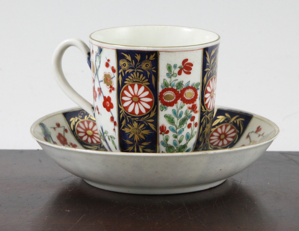 A Worcester polychrome `Queens` pattern cup and saucer, c.1770, blue fretted square seal mark to