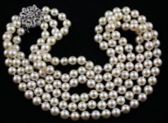 A 1960`s triple strand cultured pearl necklace with pierced 14ct white gold and diamond set clasp,