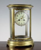 An early 20th century French gilt brass and champleve enamel four glass mantel clock, with oval