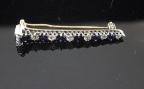 An early 20th century gold, graduated sapphire and diamond bar brooch, set with old cut stones, 1.