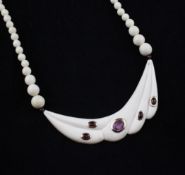 A late 1930`s/early 1940`s gem set ivory necklace, with graduated beads and fluted section set