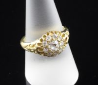 An Edwardian 18ct gold and diamond cluster ring, set with old cut diamonds, the central stone