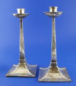 A stylish pair of Edwardian Arts & Crafts silver candlesticks by James Dixon & Sons, with square