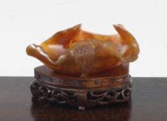 A Chinese chalcedony `lotus leaf` brush washer, 20th century, carved as a curled leaf with lotus