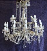 A pair of glass lustre hung Venetian style chandeliers, each with eighteen scrolling arms with facet