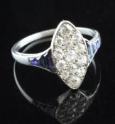 A 1940`s white gold, diamond and sapphire set marquise shaped cluster ring, set with thirteen