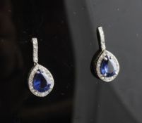 A pair of white gold, diamond and pear shaped sapphire cluster drop earrings, 0.75in.