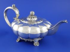 A 19th century Indian? colonial silver melon shaped teapot, with melon shaped finial and scroll