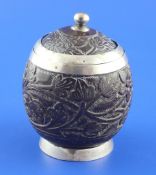 An early 19th century silver mounted coconut cup and cover, carved with foliate decoration,