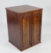 A Victorian mahogany collector`s chest, with two arched panelled doors enclosing twelve glass topped